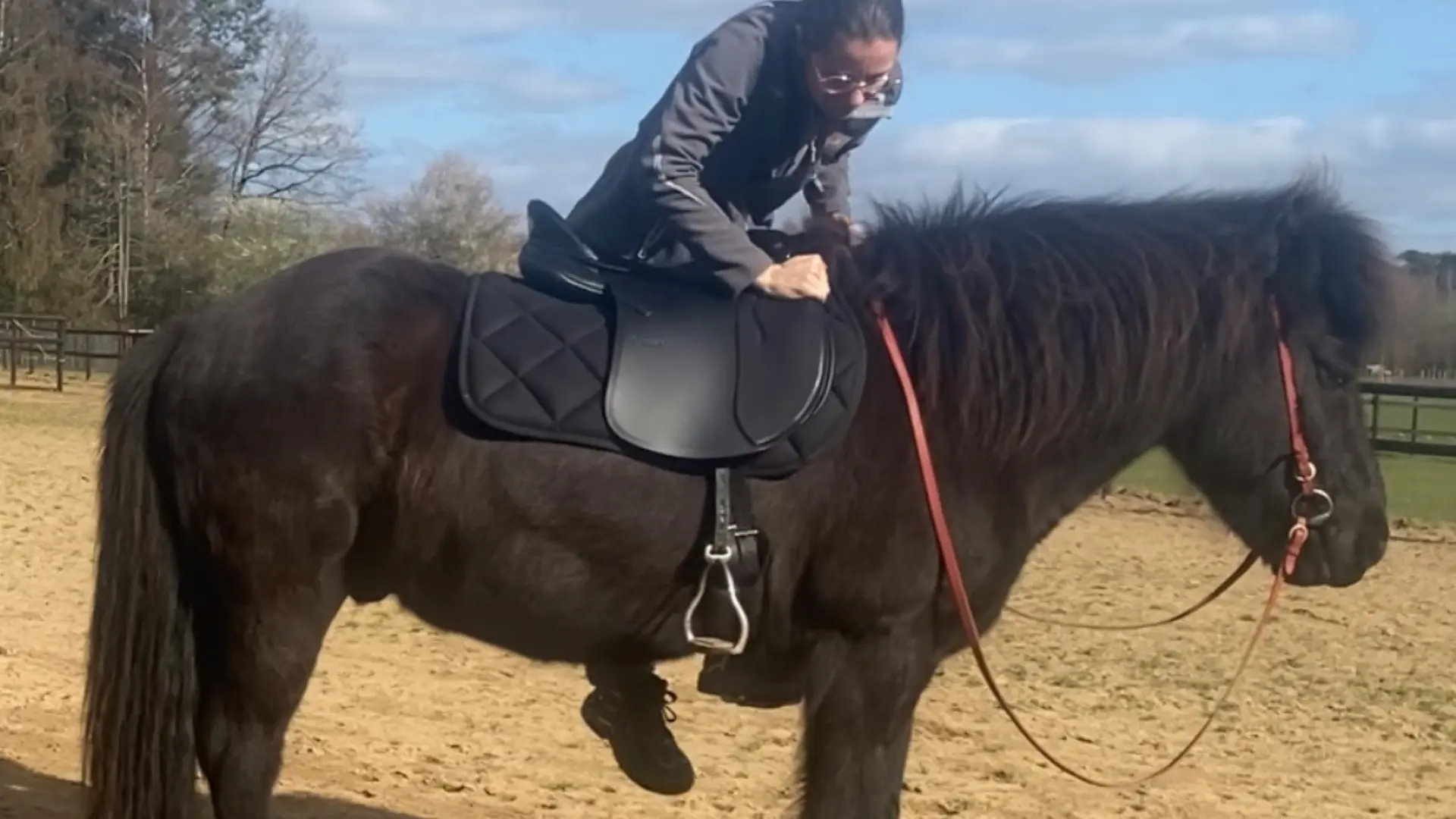 Reiterin steigt auf Pferd auf und hält den Sattel selbst in Balance